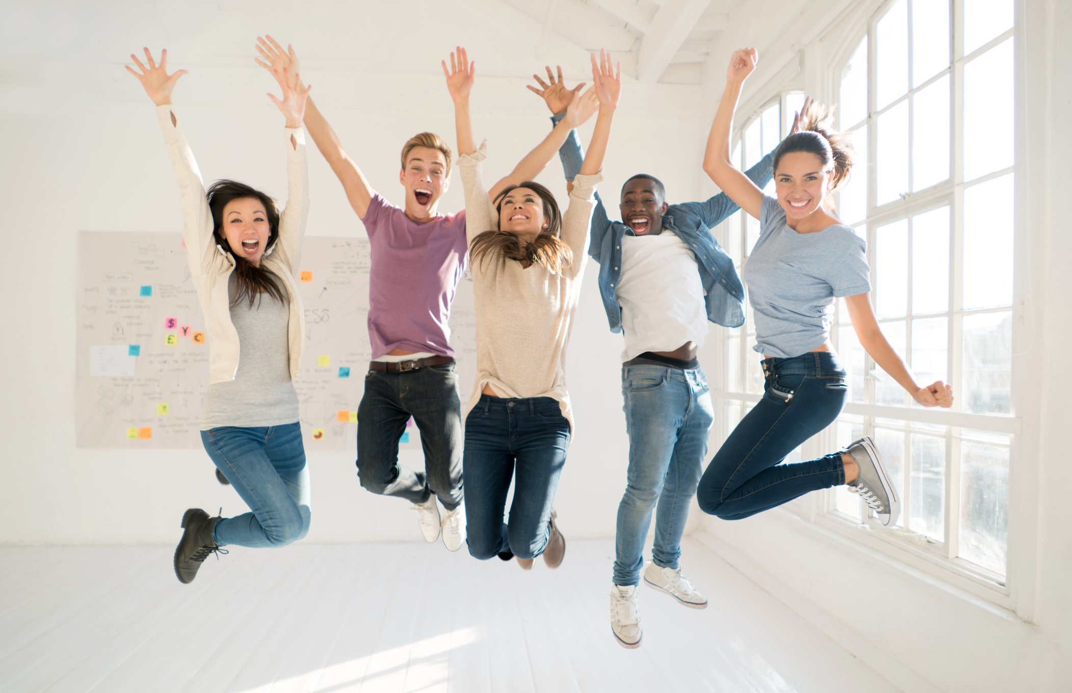 Group of roommates jumping of excitement